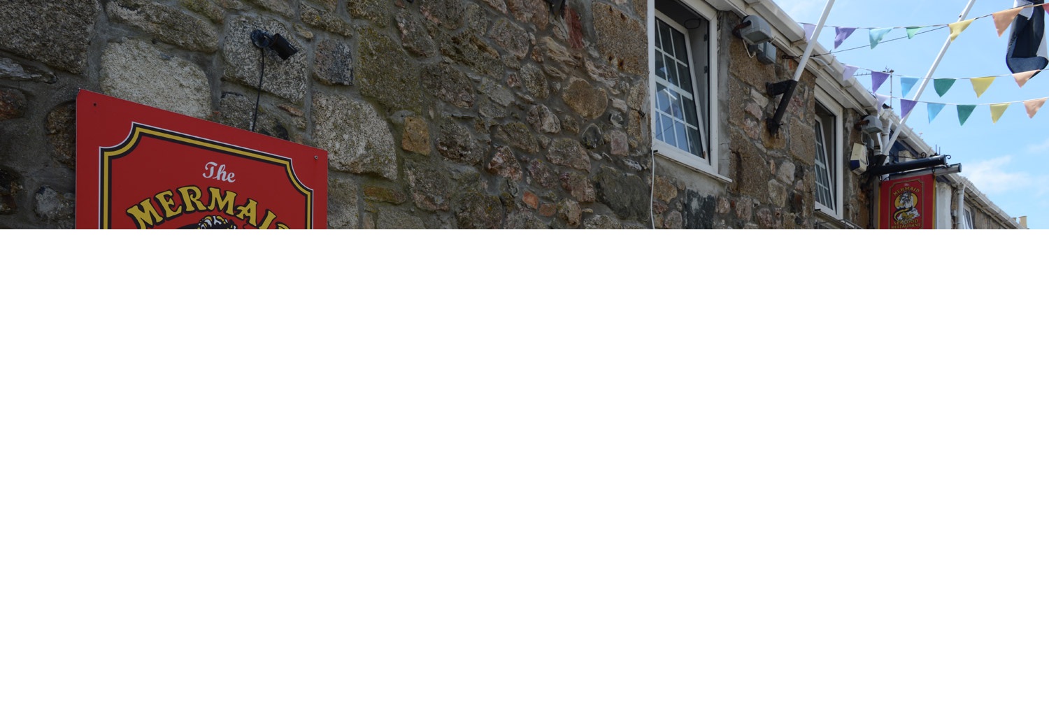 Stone walls and bunting outside The Mermaid